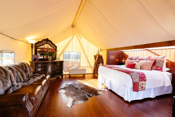 Rustic meets refinement: the interior of a luxury glamping tent at Siwash Lake with king bed and custom sky light for star gazing