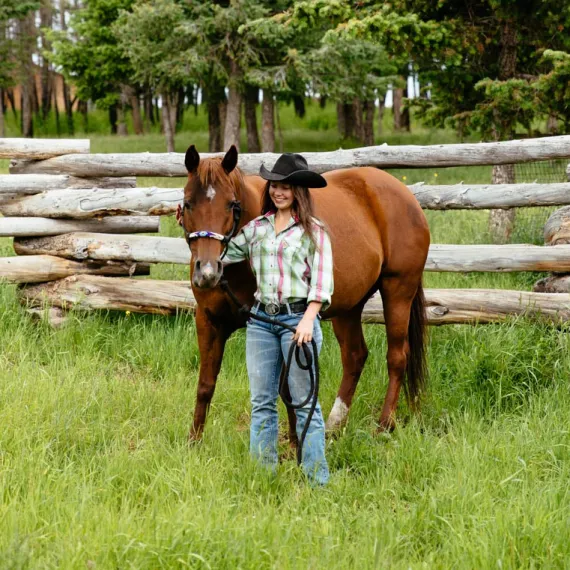 A cowgirl works with her horse during an luxury horseback riding holiday at Siwash Lake.