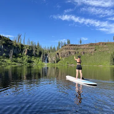 Paddle boarding in the wild amid a volcanic crater