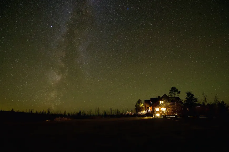 The Milky Way over the home meadow and lodge at Siwash Lake